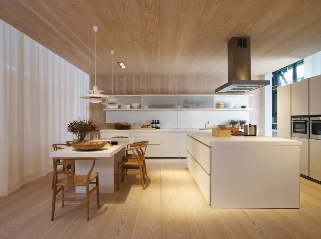Cocina con isla blanca, sillas Wishbone y suelo Dinesen Douglas