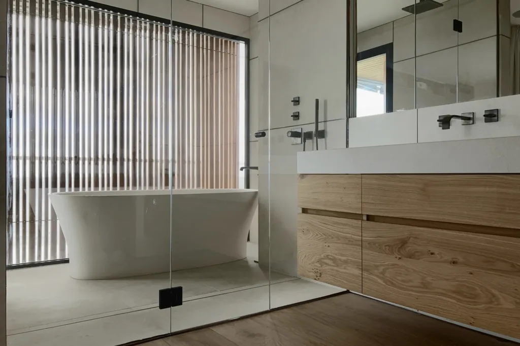 Baño con bañera y mueble de roble: el suelo Dinesen Oak Classic llega hasta la zona de la bañera, vivienda en la Costa Blanca
