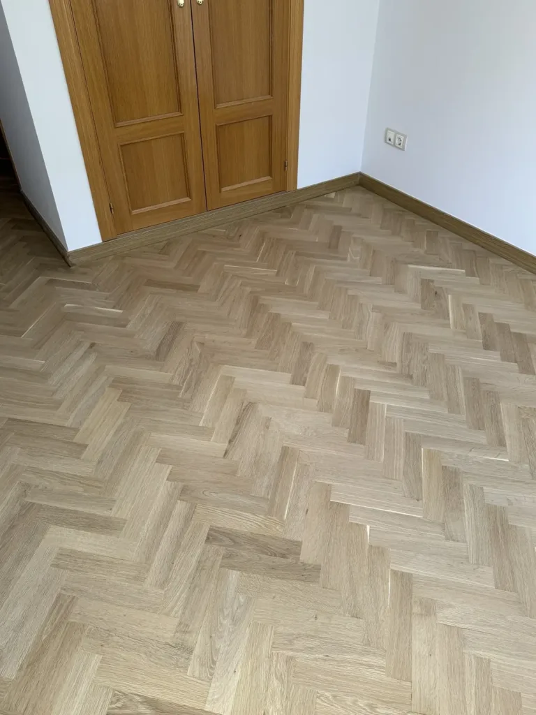 Parquet de roble en espiga terminado con Bona Traffic HD Raw frente a un armario empotrado, piso con mirador en Madrid