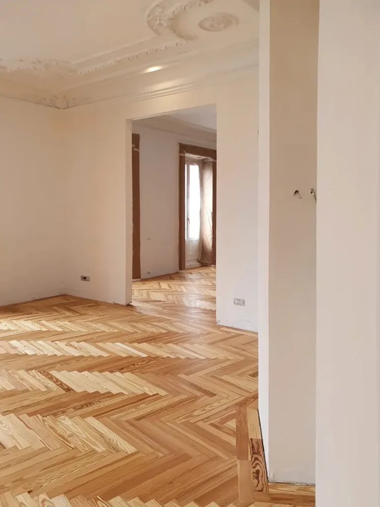Salón con parquet en espiga de pino melis viejo, vivienda en Chamberí (Madrid)